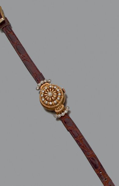 null MONTRE BRACELET de dame en or jaune et or gris 18k (750) à boîtier rond, le...