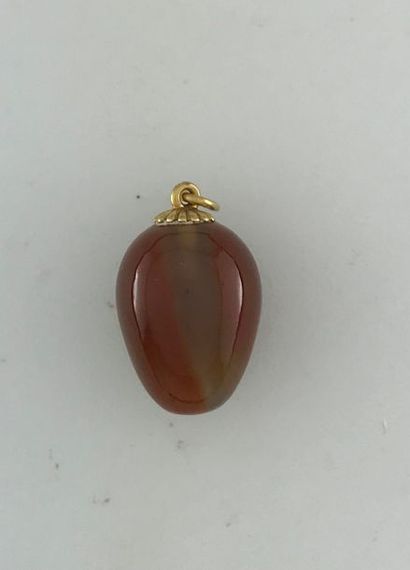 null Egg pendant in gold 750°/°°° decorated with a cornelian cabochon, Gross weight:...