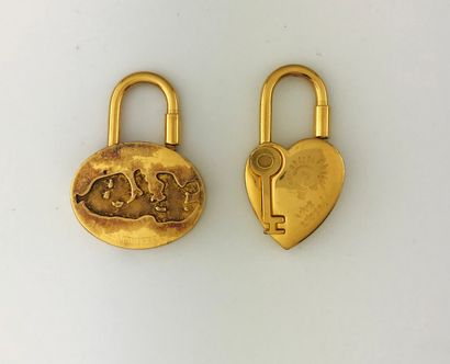 null HERMES, lot de deux porte-clefs en métal doré dans une pochette siglée, (ox...