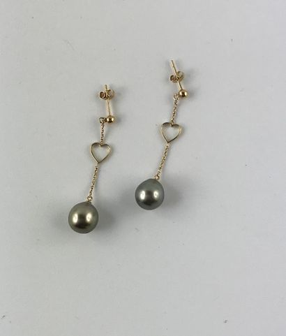 null A pair of gold earrings with a heart motif holding a Tahitian cultured pearl...