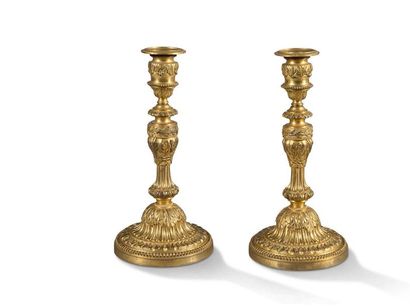 null Pair of TABLE FLAMBEAUX in chased and gilded bronze, the baluster and gadrooned...