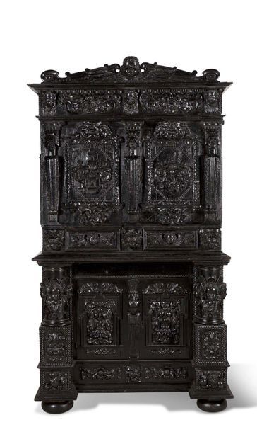 CABINET in two carved and blackened wooden...