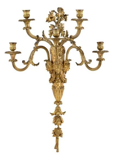 null SUITE DE QUATRE APPLIQUES
À CINQ BRAS DE LUMIÈRE en bronze ciselé et doré. Les...