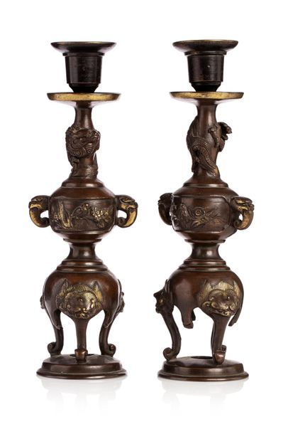null Japan, circa 1900

Pair of bronze candleholders, resting on three feet spat...