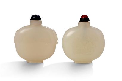 CHINE Two celadon jade flasks, gourd-shaped, one with a lapis lazuli cap, the other...