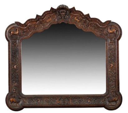 LARGE COLONIAL MIRROR with a richly carved...
