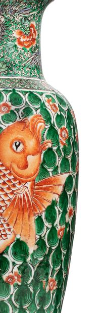 CHINE 
A green family enamelled porcelain vase decorated with coral carp on a green...