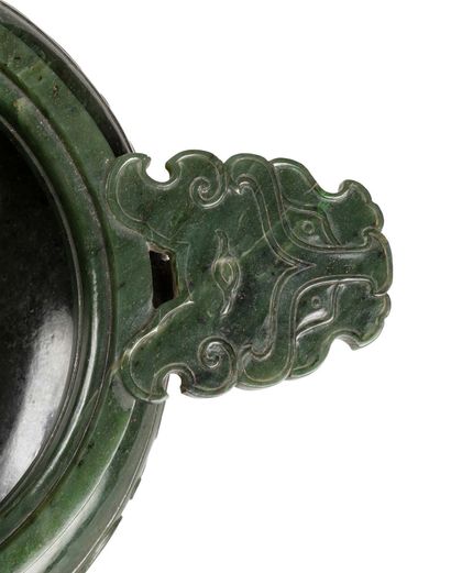 CHINE 
A tripod covered incense burner made of carved spinach green jade, the lid...