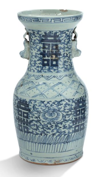 CHINE 
A blue-white porcelain vase decorated with foliage scrolls and stylized characters,...