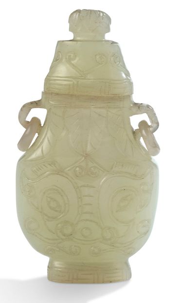 CHINE 
A small celadon jade Hu-shaped vase, decorated with stylized taotie masks...