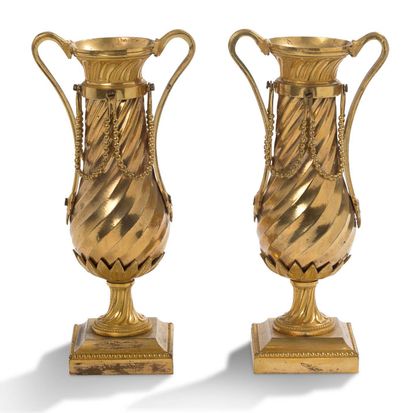 null 
Pair of baluster-shaped vases, the body with twisted flutes decorated with...