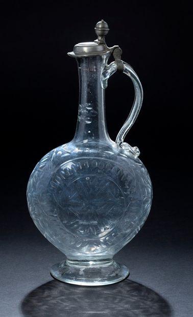 null A cut glass decanter with geometrical decoration of stylized flowers, high neck...