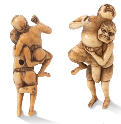 JAPON XIXE SIECLE Ivory netsuke enhanced with brown, representing two sumo wrestlers,...