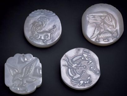CHINE Quatre plaquettes en jade blanc à décor sculpté en léger relief XXème siècle....
