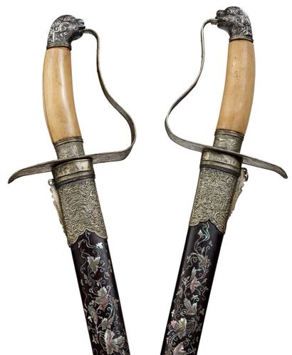 VIETNAM XIXe siècle 
Two steel-bladed swords with a bone handle ending in a zoomorphic...