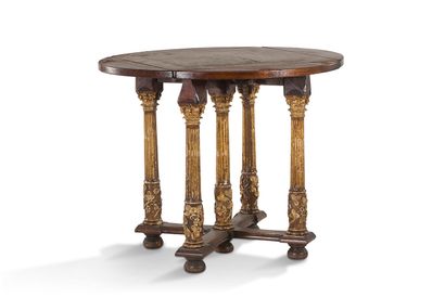 null 
+ Circular oak table with flaps. Five-legged gilt Corinthian columns with vine...