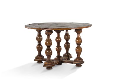 null 
+ Walnut table with flap top. Legs with five ringed columns, connected by a...