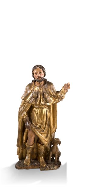  + 雕刻、镀金和多色木制的圣洛奇。 穿着朝圣者的服装，圣人举起衣服的一部分，展示他右腿上的泡泡，狗在他身边。...