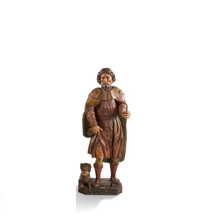  + 雕刻和上色的胡桃木的圣罗赫，粗糙的背面。 他身穿朝圣者的斗篷，正在揭开他右腿上的泡泡，供应狗躺在他的脚边。...