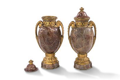null Pair of ovoid vases in pink breccia marble and gilded bronzes, on a pedestal...