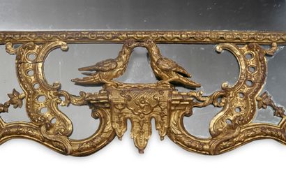 null 
A MONUMENTAL MIRROR with carved and gilded wood glazing, richly decorated with...