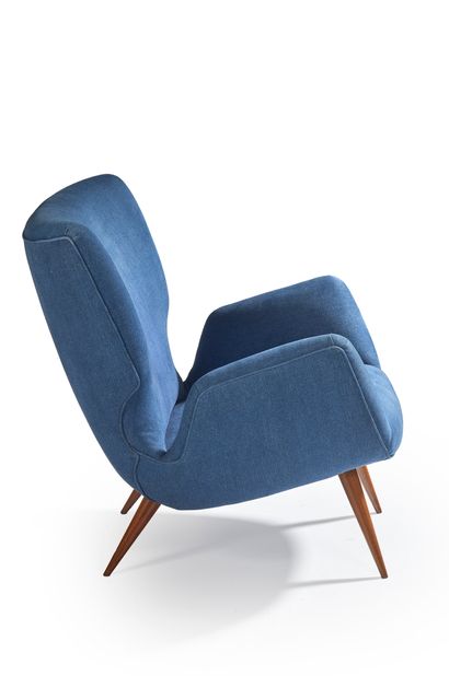 CARLO HAUNER ET MARTIN EISLER A large - backrest armchair covered with “blue jean”...
