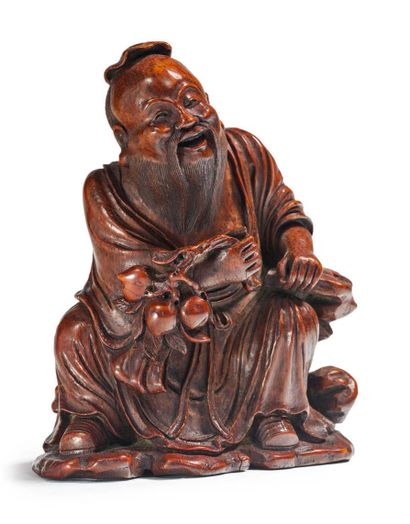 Chine XIXe siècle 
Sujet en bois sculpté de belle patine représentant Shoulao assis...