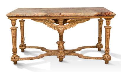 null A carved and gilded wood table, it rests on four uprights in sheath with lions'...