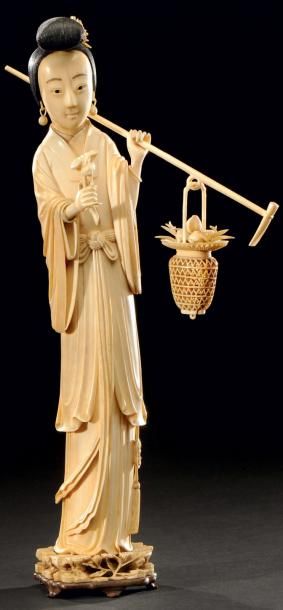 CHINE Grand sujet en ivoire sculpté représentant une dame de cour portant un panier...