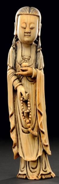 CHINE Sujet en ivoire sculpté représentant la déesse Kwanhin tenant un flacon Fin...