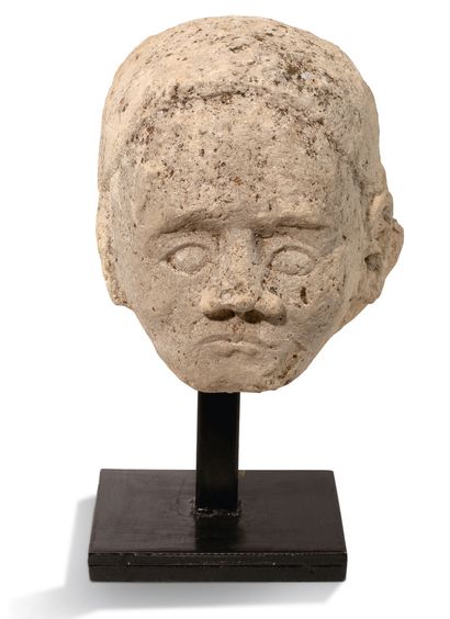 Head in sculpted limestone. Face with a high...