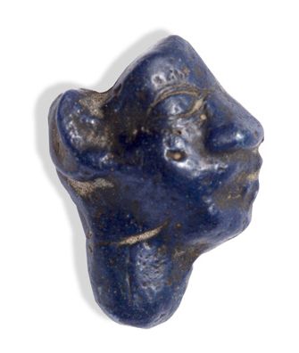 null INCRUSTATION FIGURE in dark blue tinted glass paste representing a royal or...