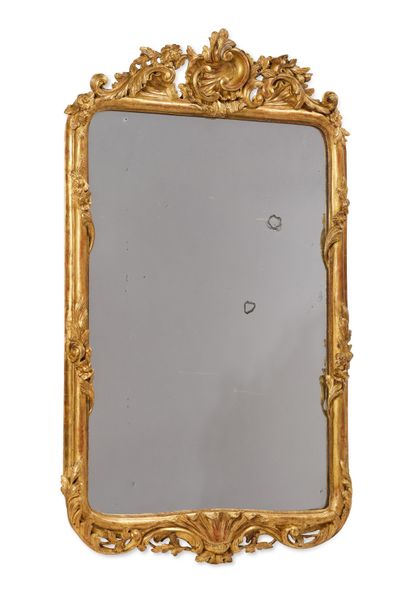 null Gilded and carved wood mirror decorated with a large asymmetrical shell framed...