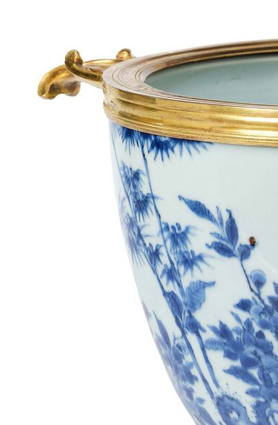 null A Chinese porcelain cup, blue and white, on a chased and gilded bronze frame,...