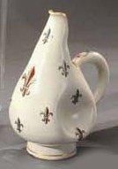 EMILE GALLE (1846-1904) Pot à lait en faïence polychrome rehaussée d'or à décor de...