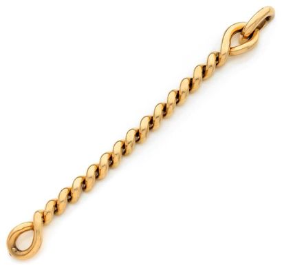 HERMES Bracelet "torsade" en or jaune godronné, fermoir invisible formant une boucle....