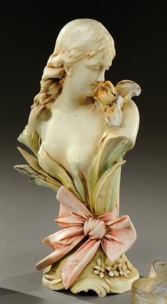 AMPHORA Buste en porcelaine polychrome figurant une jeune femme humant une fleur....