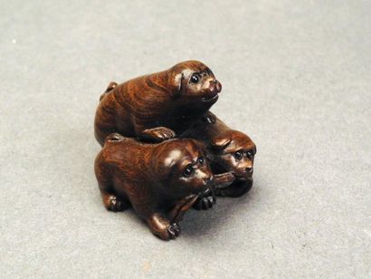 JAPON Netsuké en bois sculpté représentant trois chiens jouant avec une corde H:...