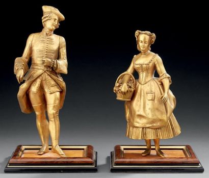 null Deux statuettes en bronze ciselé et doré, figurant un couple d'élégants. Fin...