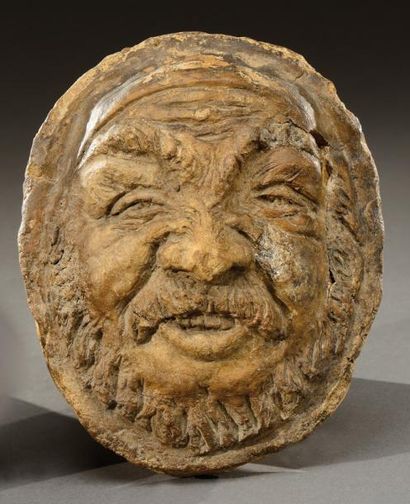 JEAN CARRIES, attribué à Masque en grès brun à décor d'un visage de satyre en relief....