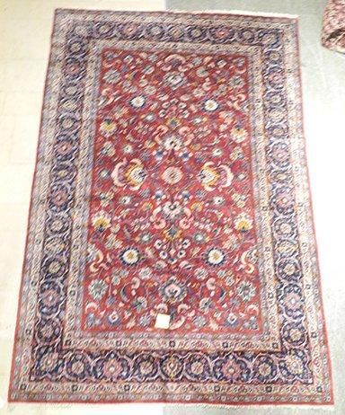 null KACHAN-KORK - Iran Grand et fin tapis à champ rubis à décor de semis de palmettes...