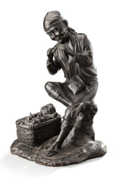 null Statuette en bronze ciselé et patiné représentant un paysan oriental assis près...