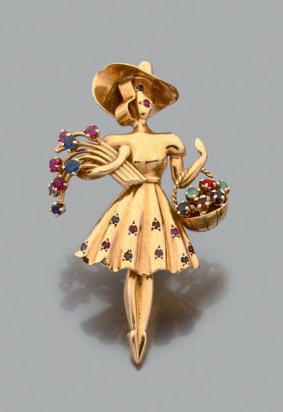 Lacloche Broche en or jaune 18K "femme aux fleurs" rehaussée de saphirs et rubis....