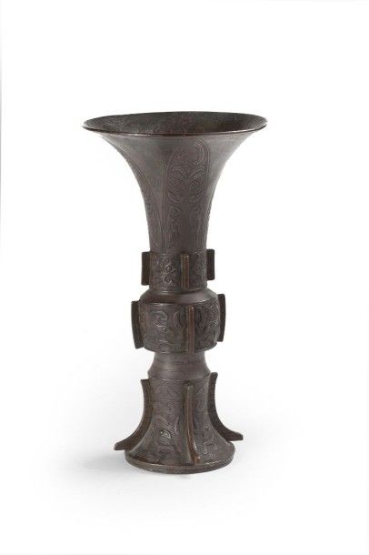 CHINE Vase cornet en bronze à patine brune à motifs dans le style archaïque de palmes...