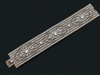 null Large bracelet articulé formant un ruban en platine et or gris 18k à décor ajouré...