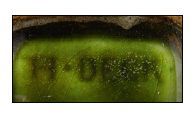 Théodore DECK (1823-1891) Encrier en faïence verte à décor en relief de deux mufles...