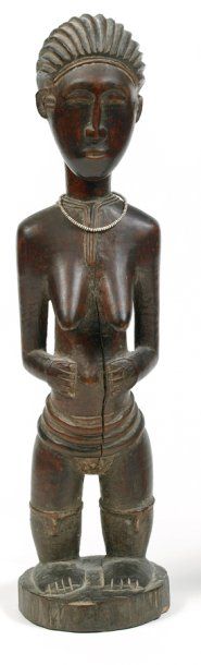 null Gouro. (Côte-d'Ivoire) Bois. H.: 35,5cm Statuette féminine debout les mains...