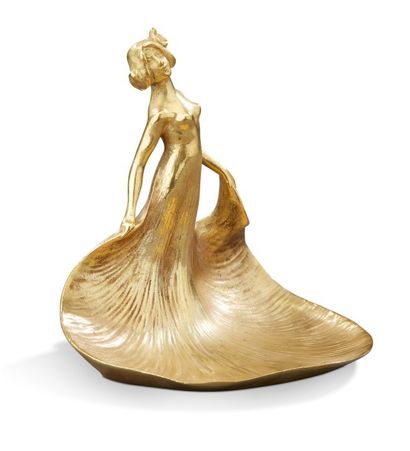 TRAVAIL 1900 Vide-poche en bronze figurant une femme à longue robe.
H: 13 cm L: 13...