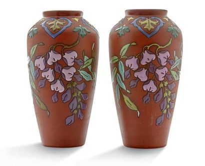 LONGCHAMP 
Paire de vases en céramique à décor émaillé de fleurs et motifs végétaux...