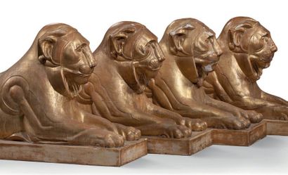 null SUITE DE QUATRE LIONS COUCHÉS en bois sculpté et doré.
Ils reposent sur des...